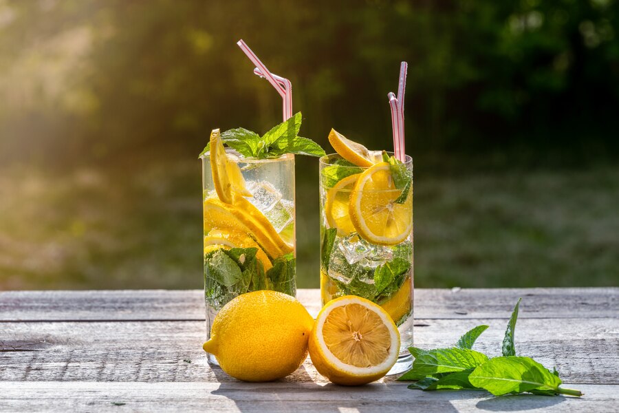 summer concept homemade lemonade with lemon mint ice glasses old wooden table outdoor_73966 2359